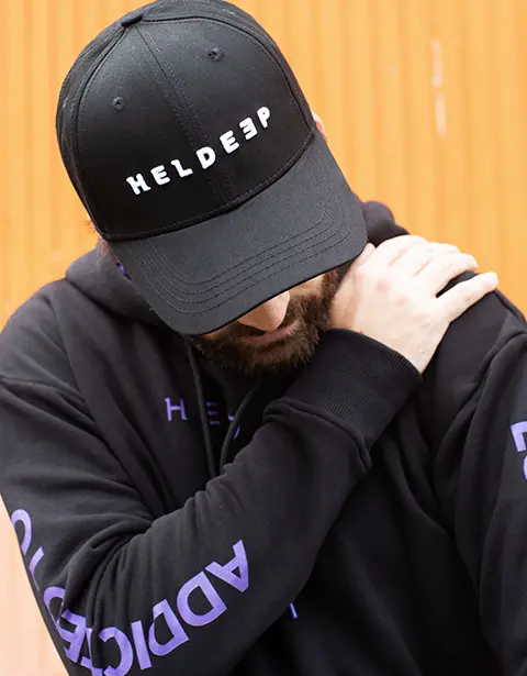 Oliver Heldens in a black Heldeep cap and hoodie